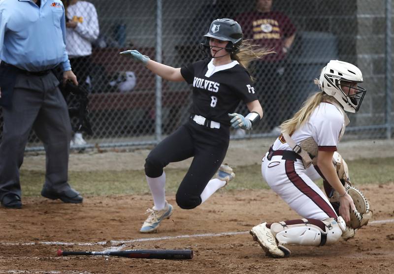 Prairie Ridge's Ady Kiddy slides into home plate to score as Richmond-Burton’s Rebecca Lanz waits for the throw during a nonconference softball game on Tuesday, March 18, 2025, at Richmond-Burton High School.