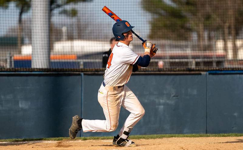 Oswego’s Trey Hernandez (14) drives in a run against Plainfield South during a baseball game at Oswego High School on Monday, April 11, 2022.