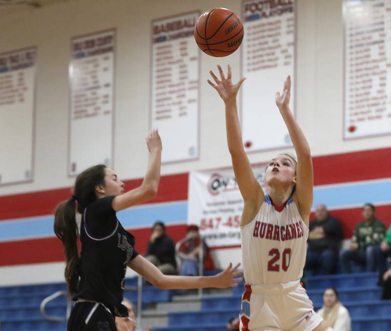 Marian Central's Adriana Ross shoots the ball over Rockford Lutheran's Kaylee Bankes during a non-conference girls basketball game Monday, Dec. 12, 2022, between Marian Central and Rockford Lutheran at Marian Central Catholic High School, in Woodstock.