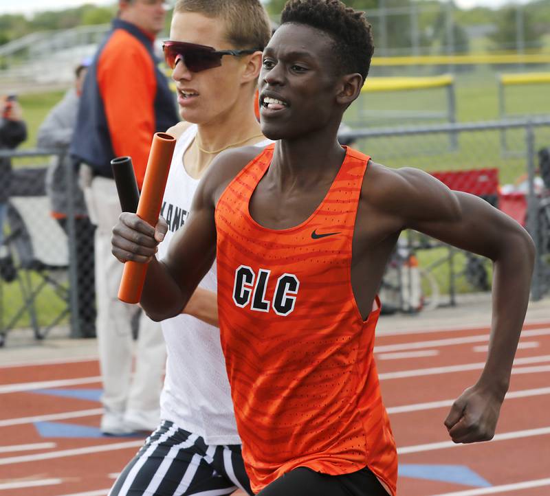 Crystal Lake Central’s Amana Omale and Kaneland’s Evan Whildin run neck to neck as the race in the 4 x 800 meter relay during the Huntley IHSA Class 3A Boys Sectional Track and Field Meet on Thursday, May 22, 2025, at Huntley High School.