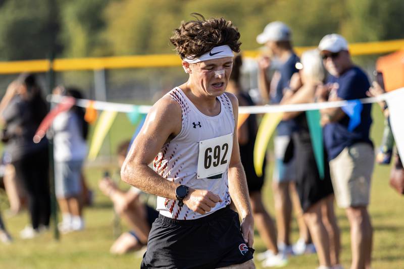 Plainfield East’s Grant Withaeger crosses the finish line at the Locktoberfest three-mile varsity cross country race at Dellwood Park in Lockport on October. 4, 2025.