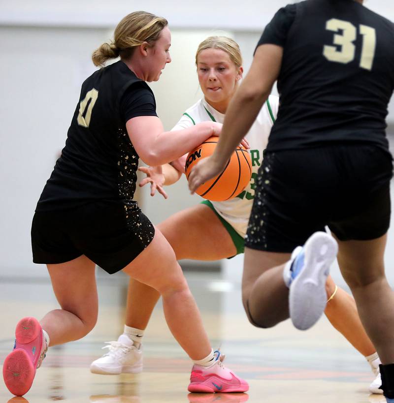 Crystal Lake South's Laken LePage tries to steal the ball from Grayslake North's Jane Pritchard during a Northern Illinois Holiday Classic semifinal girl basketball game on Tuesday, Dec. 16, 2025, at McHenry High School.