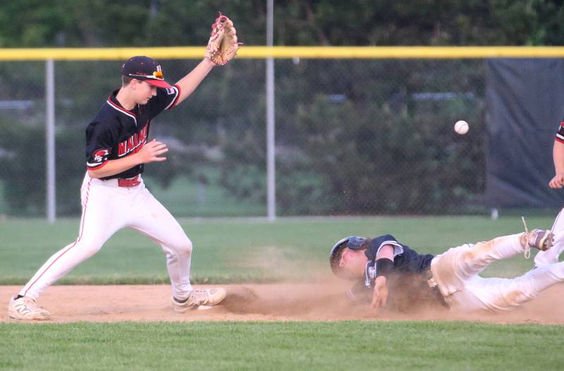 Lexington's Jack Miller slides into second base after stealing the bag as the ball gets by Henry-Senachwine's Landon Harbinson during the Class 1A Sectional semifinal game on Wednesday, May 28, 2025 at Schwieckert Stadium in Peru.