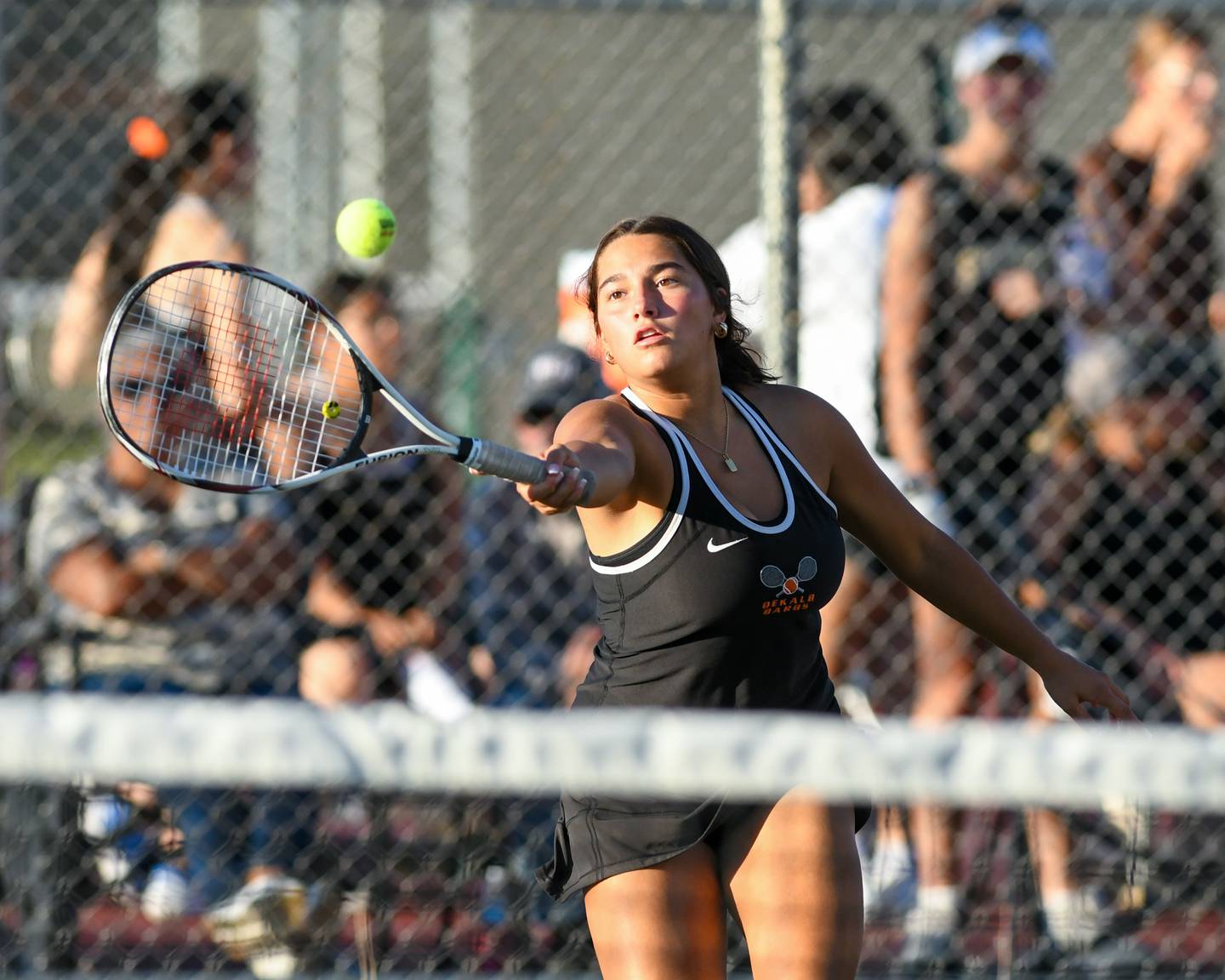 Emma Hart of DeKalb serves the ball during the second doubles match while taking on Sycamore on Thursday Sept. 25, 2025, held at DeKalb High School.