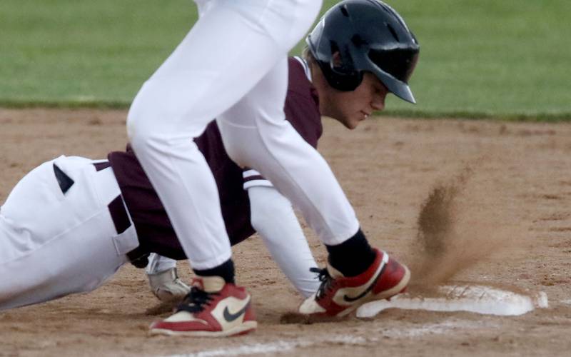 Prairie Ridge's Maddon Mckim dives back to first base during a Fox Valley Conference baseball game against Huntley on Friday, May 1, 2026, at Prairie Ridge High School.