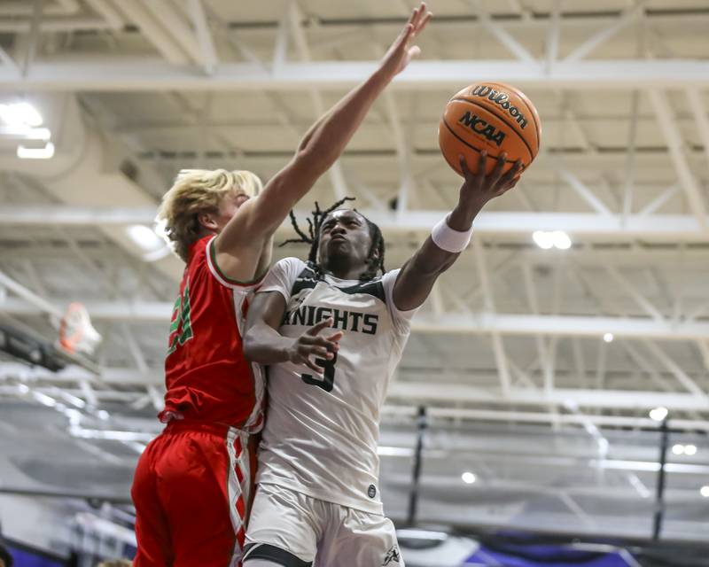 Kaneland's Marshawn Cocroft (3) puts in a lay up over the defense during their Plano Christmas Classic semi-final basketball game between Kaneland at LaSalle Peru Monday, Dec 29, 2025 in Plano.