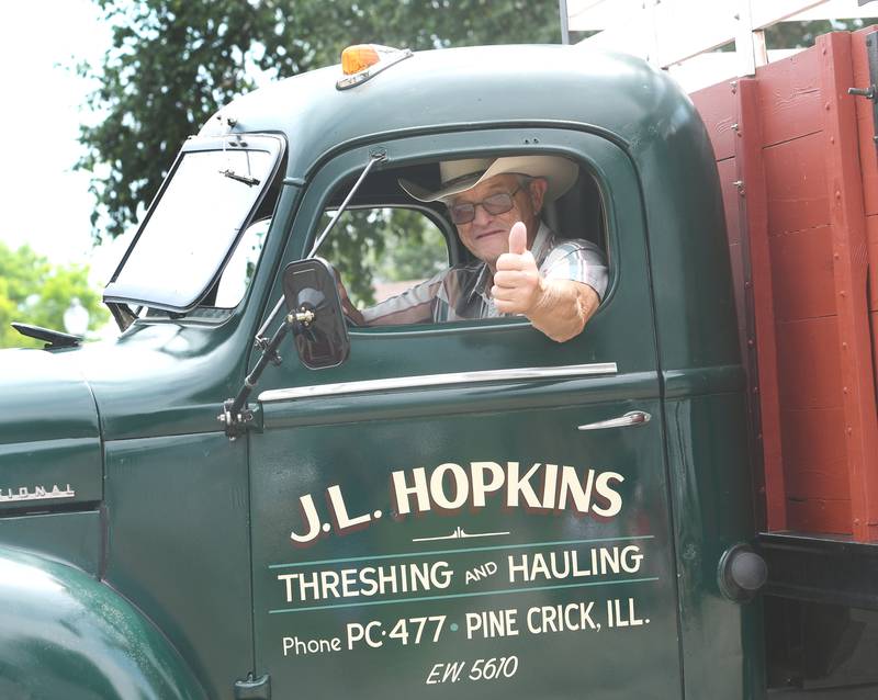 Jim Hopkins, of rural Mt. Morris, gives a thumbs up as he drives his antique truck in the Let Freedom Ring Grand Parade on July 4 in Mt. Morris.