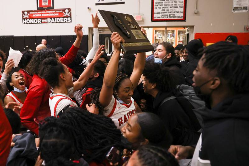 Bolingbrook’s Kennedi Perkins holds up the championship plaque for the fans after their 61-50 win against Homewood-Flossmoor in the Class 4A Bolingbrook Sectional championship. Thursday, Feb. 24, 2022, in Bolingbrook.