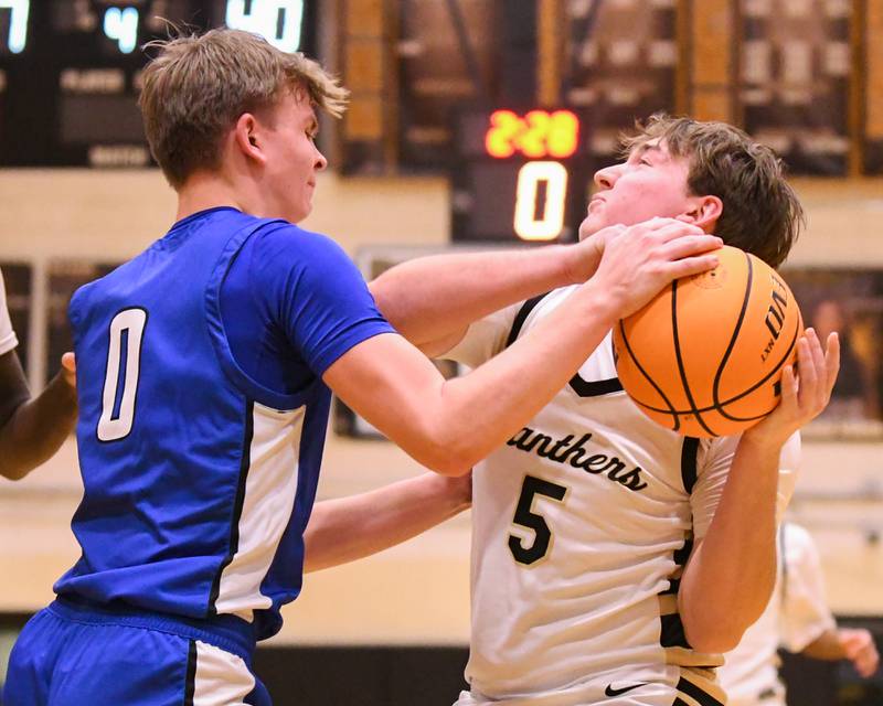 Geneva's Dane Turner (0) blocks the shot of Glenbard North's Kristian D'Alexander (5) during the game on Tuesday Jan. 5, 2025, while traveling to Glenbard North High School.