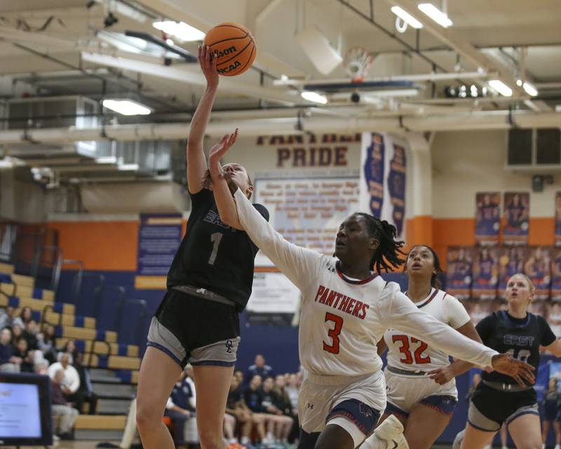 Oswego East's Aubrey Lamberti (1) is fouled by Oswego's Madelyn-Jordan Mensah during their basketball game between Oswego East at Oswego Friday, Jan 09, 2026 in Oswego.