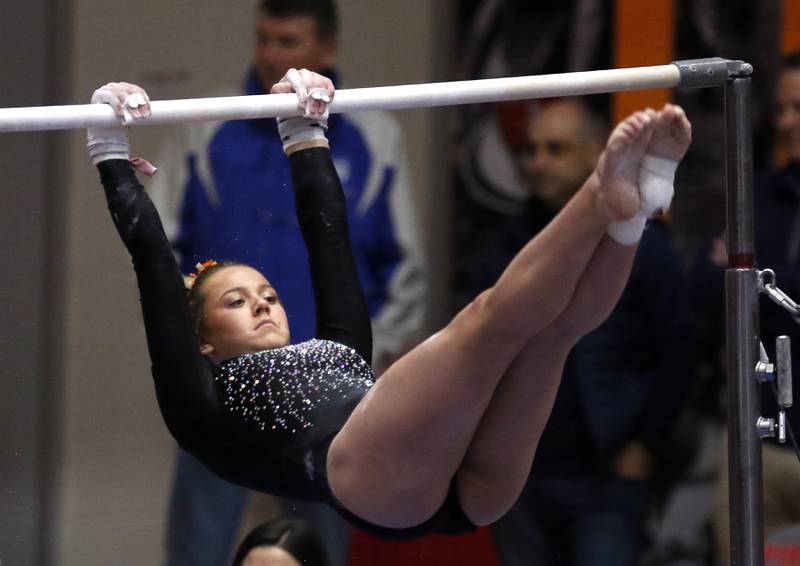 DeKalb's Eden Russell competes in the preliminary round of the uneven parallel bars Friday, Feb. 17, 2023, during the IHSA Girls State Final Gymnastics Meet at Palatine High School.