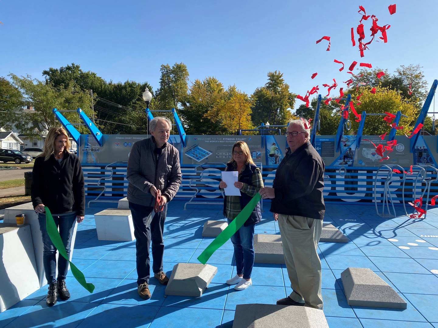 Tami Koppen, Lloyd Chapman, Commissioner Marla Pearson and Mayor Dan Aussem cut the ribbon on the new fitness court at Kiwanis Park in Ottawa.