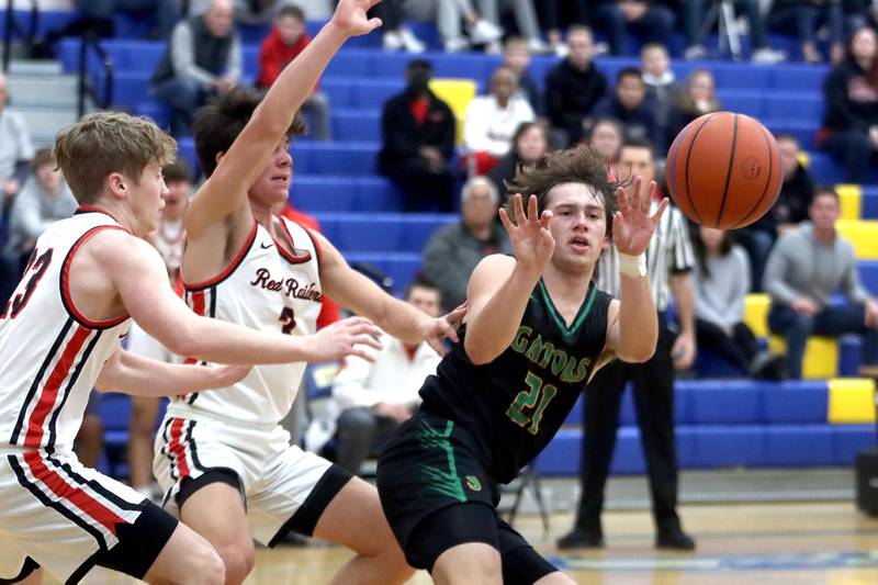 Crystal Lake South’s Cooper LePage dishes the ball out of heavy traffic against Huntley during the title game of the Johnsburg Thanksgiving tournament in boys basketball on Friday.