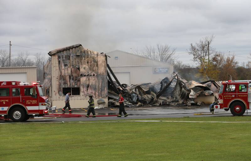 Ottawa and Wallace  firefighters work the scene of a large fire at Conroy's Automotive and 24 Hour Towing building on Wednesday, Nov. 6, 2024 in Ottawa. Fire departments from Wallace, Grand Ridge, Senera, Seneca, Utica and Peru all responded to the blaze.