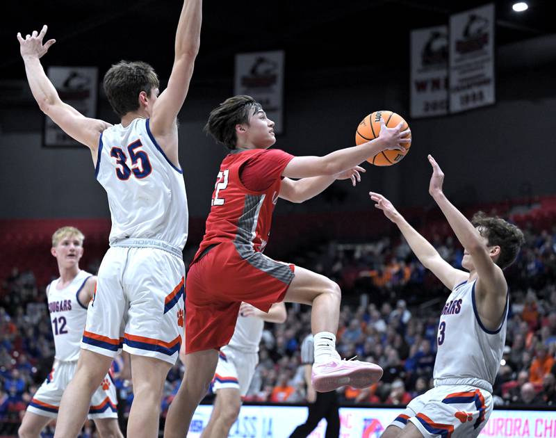 Aurora Christian’s Jacob Baumann commits a foul against Eastland’s Tanner Stern as he goes to the basket in a IHSA Class 1A boys basketball supersectional at Northern Illinois University in DeKalb on Monday, Mar. 10, 2025.