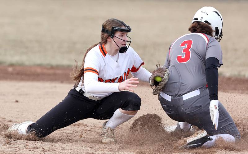 DeKalb’s Hazel Montavon applies a late tag to Rockford Auburns Jayden Moss who records a stolen base during their game Wednesday, March 15, 2023, at DeKalb High School.