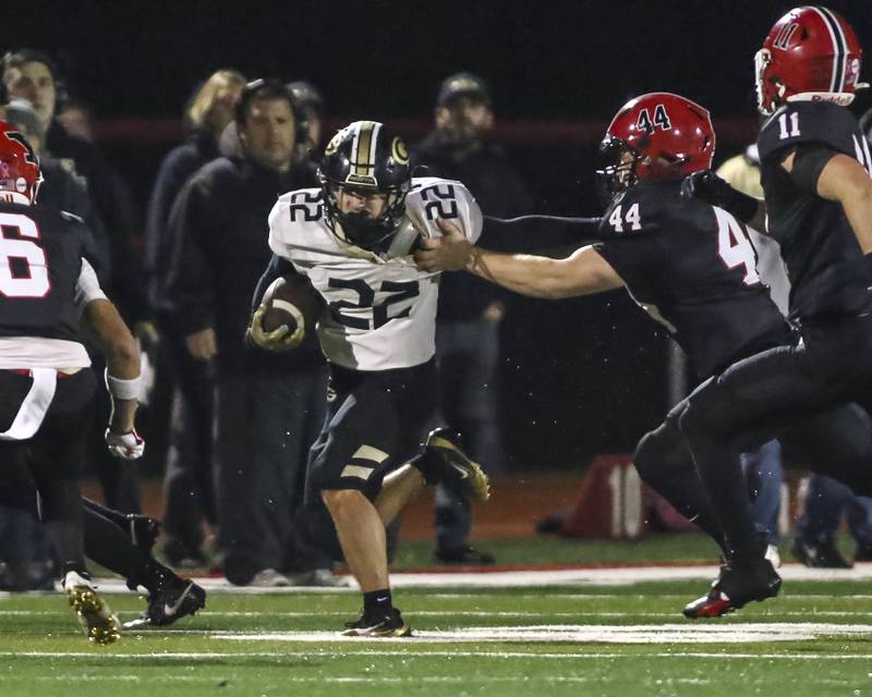 Glenbard North's Donato Gatses (22) runs fights off a tackle attempt by Yorkville's Ben Wade (44) during Class 7A first round football game between Glenbard North at Yorkville. Friday, Oct 31, 2025 in Yorkville.
