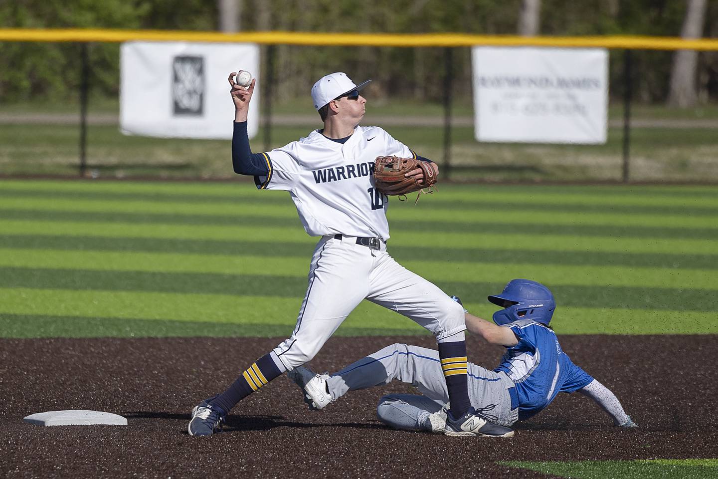 Newman’s Garret Matznick works to break up a double play from Sterling’s Trevor Dir Wednesday, May 3, 2023.