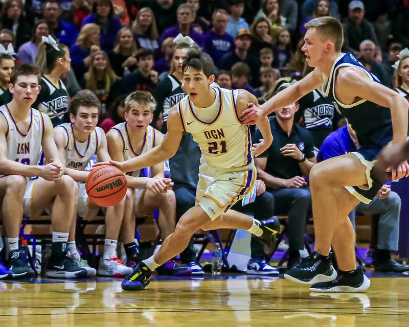 Downers Grove North's Jack Stanton (21) drives around Downers Grove South's Justin Sveiteris (44) during basketball game between Downers Grove South at Downers Grove North. Dec 16, 2023.