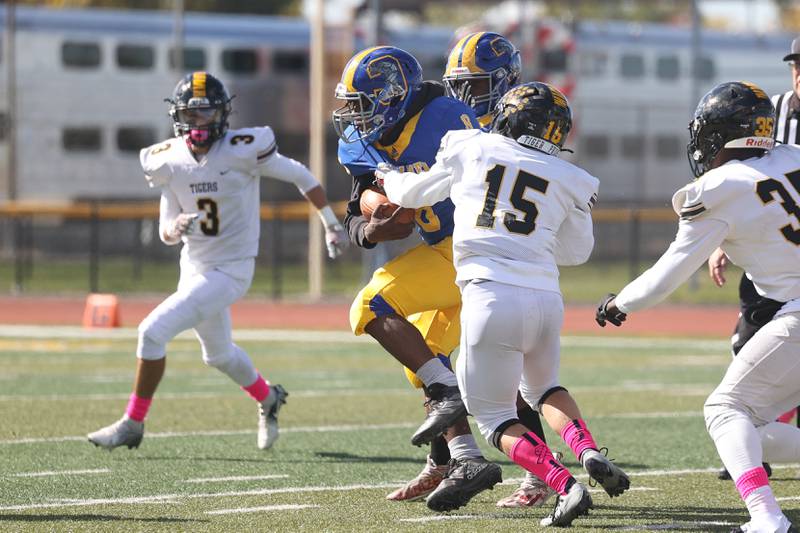 Joliet Central’s Jaylen Murphy powers ahead for a first down against Joliet West on Saturday.