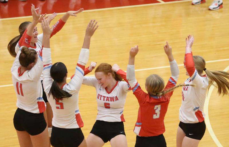 Members of the Ottawa volleyball team celebrate after scoring a point against Pontiac on Tuesday, Sept. 9, 2025 at Kingman Gymnasium.
