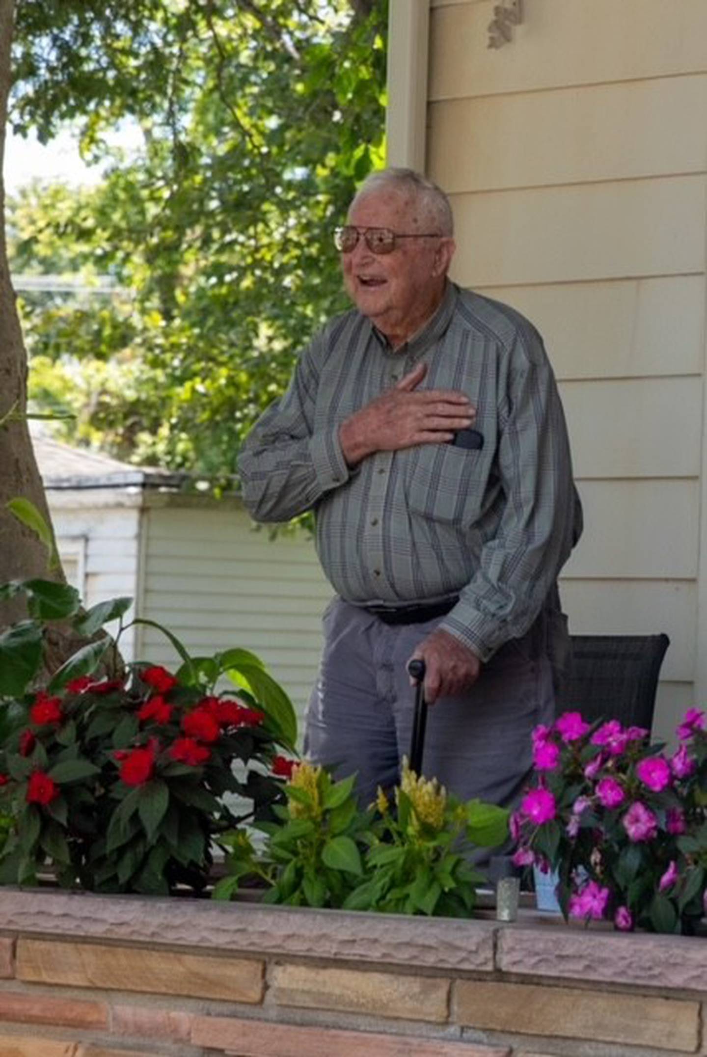 Willard Simpson of Franklin Grove reacts with surprise Sunday, Aug. 11, 2024, as Mendota veterans salute him during his visit to the Sweet Corn Festival. Simpson, who turns 100 on Sept. 3, participated in the Battle of the Bulge and friend Deana Falchook of Mendota thought that merited the praise of local veterans. VFW Post 4079 agreed and detoured from the Sweet Corn procession to salute Willard.