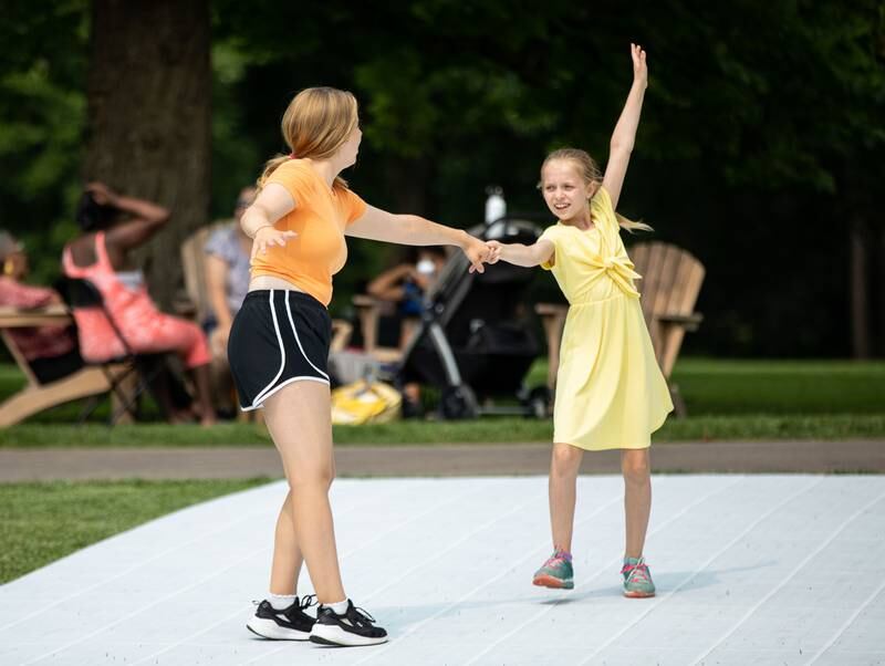 Alexandria (15), left, and Amarisha (9) dance to music by the band Zazz during the Voyage en France Fest at Cantigny in Wheaton on Sunday, July 16, 2023.