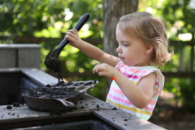 Mira Bachus, 3-years old from Coal City, makes mud muffins at the Children’s Garden in Elwood. The Children’s Garden in Elwood recently celebrated their 25th anniversary. Saturday, July 9, 2022 in Elwood.