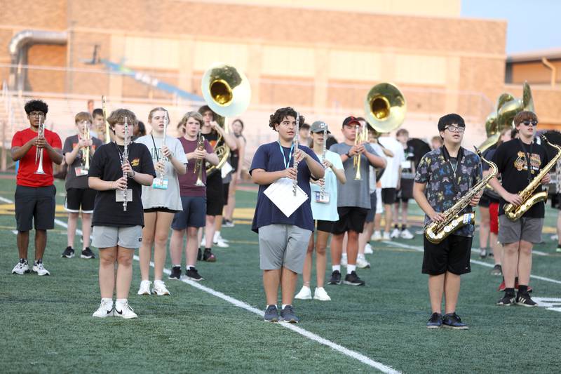 Members of the Batavia High School marching band walk through their choreography with their instruments during band camp at the school on Tuesday, July 30, 2024.