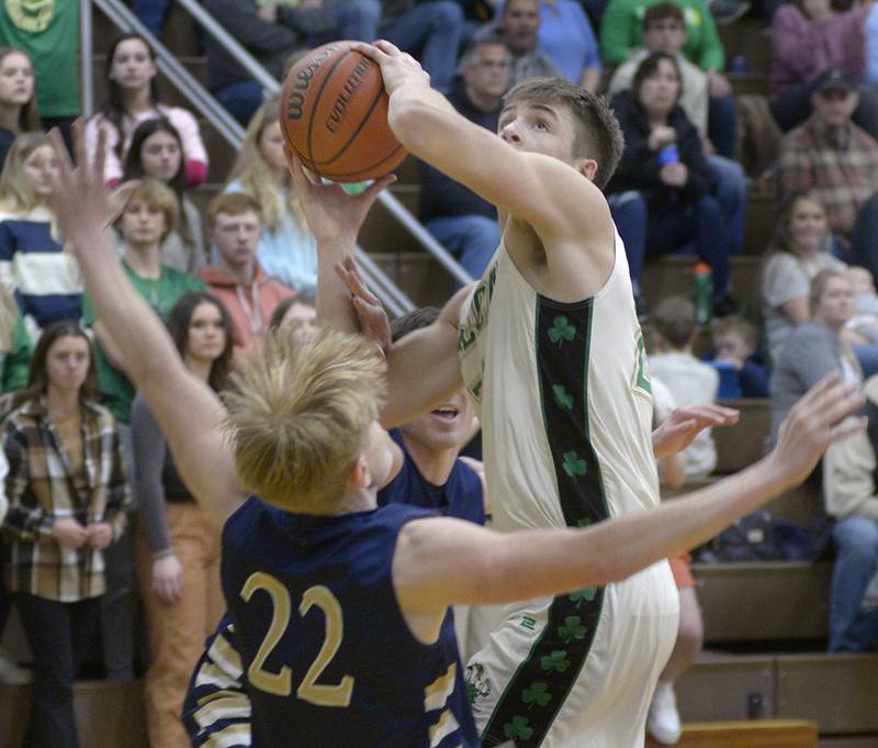 Seneca’s Lane Provance eyes the basket as he gets a shot away from the block attempt of Marquette’s Henry McGrath Tuesday during the 2nd period at Seneca.