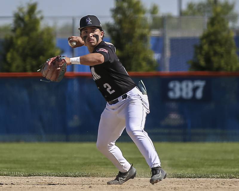 Oswego East's Devin Wheaton (2) throws to first after fielding a grounder at second during baseball game Oswego East at Oswego.  May 14, 2026 in Oswego.