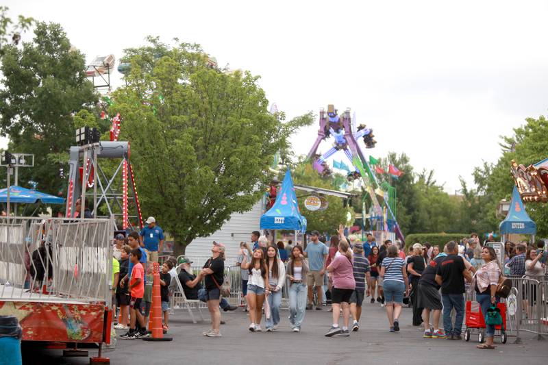 Patrons walk the midway during 156th Annual Kane County Fair on Thursday, July 17, 2025 in St. Charles. The fair runs through Sunday, July 20, 2025.