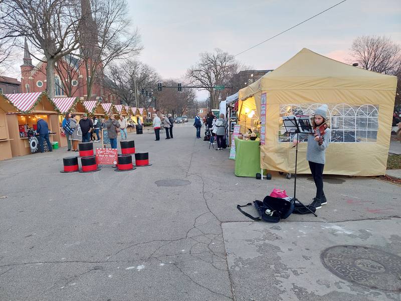 Warmer-than-normal temperatures brought out shoppers Friday, Dec. 8, 2023, for the Chris Kringle Market on Jackson Street in downtown Ottawa.