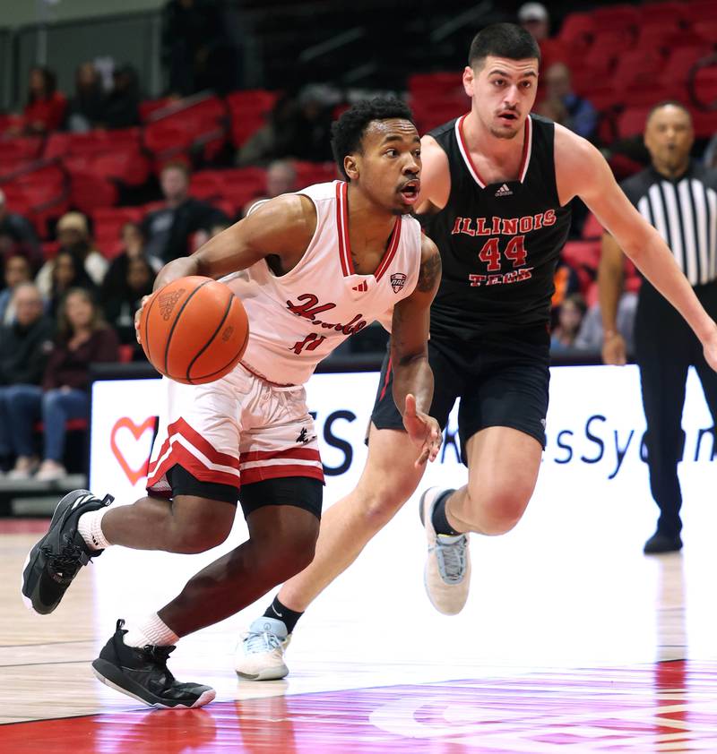 Northern Illinois' David Coit drives by Illinois Tech's Sultan Abuissa during their game Monday, Nov. 13, 2023, at the NIU Convocation Center in DeKalb.