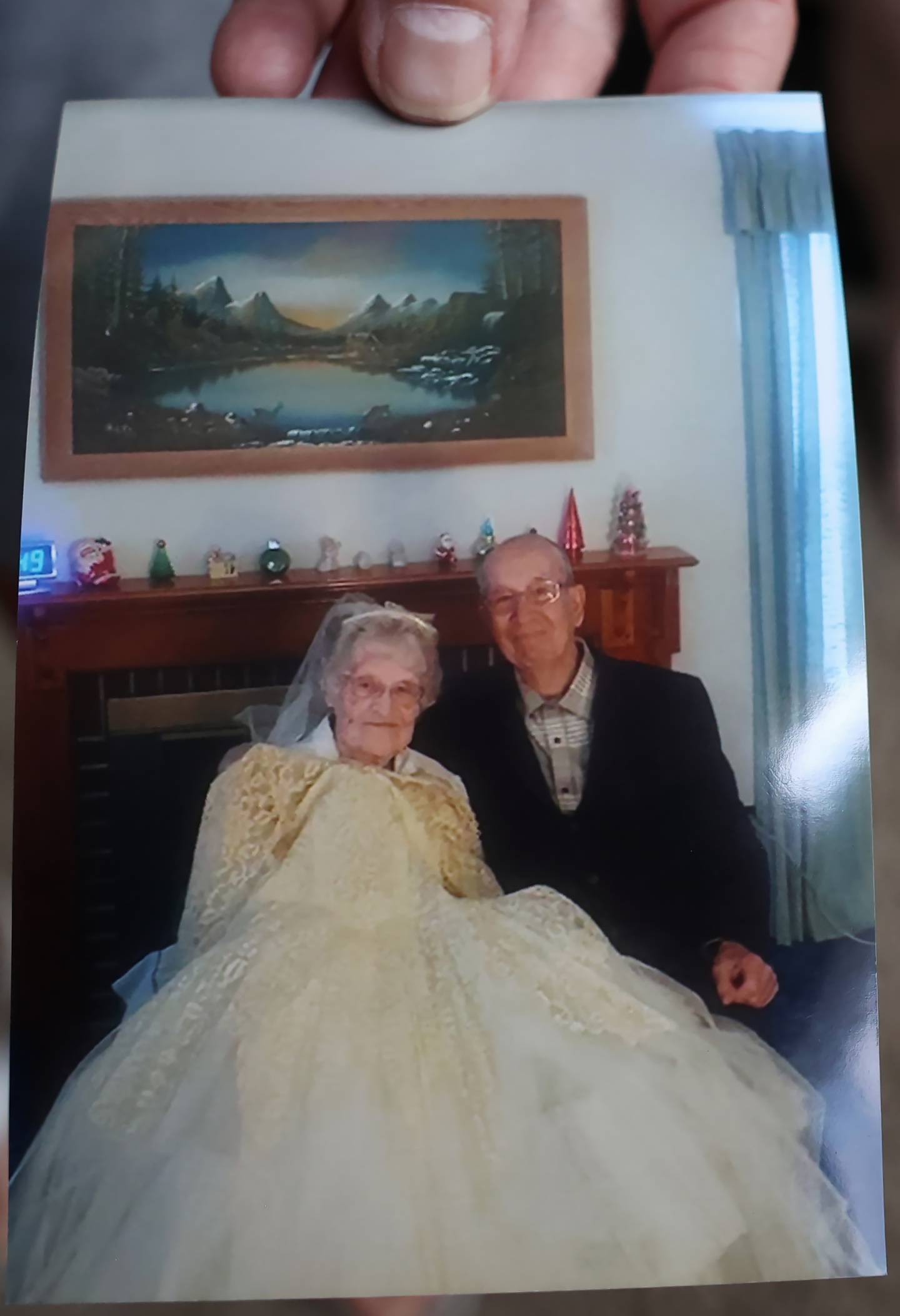 A photo depicts a yearly tradition of Patricia and Wayne McCarty in which she would don her wedding dress every year on their wedding anniversary, May 12, 1956, and pose for a photo together.