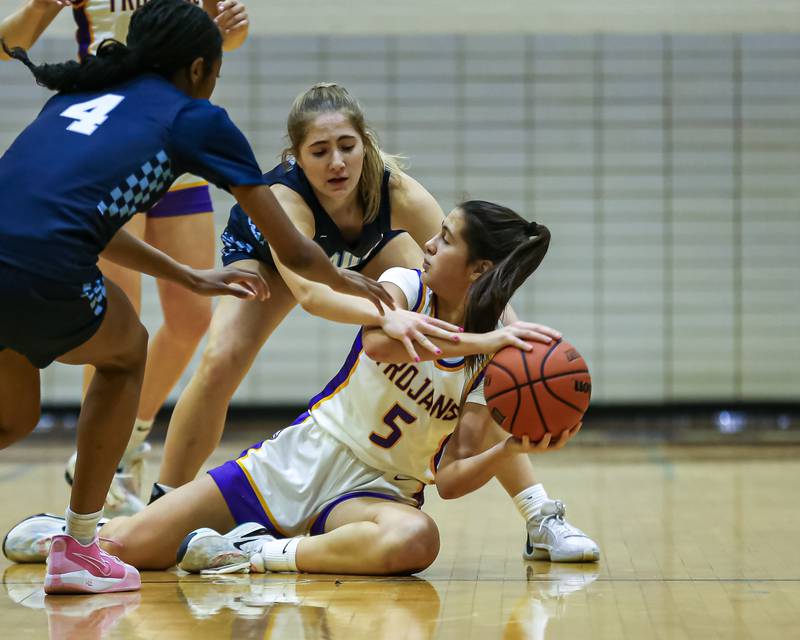Downers Grove North's Campbell Thulin (5) battles for possession during girls basketball game between Downers Grove South at Downers Grove North. Dec 16, 2023.
