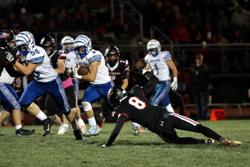 Princeton's Ace Christiansen gets a block from teammate Owen Hartman (56) and steers clear of E-P's Connor Keegan (8) in Friday's game at Prophetstown. The Tigers won 61-14.