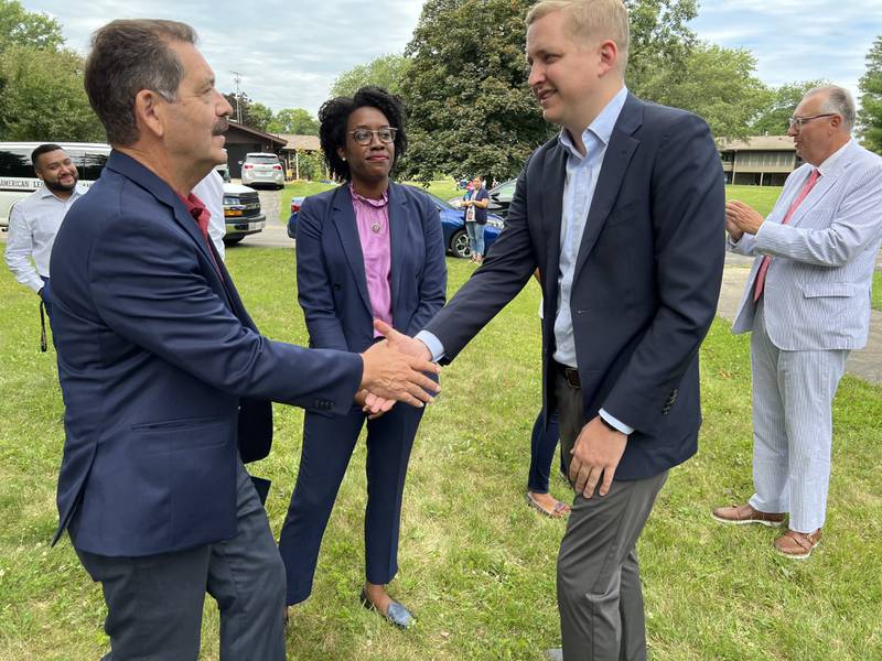 U.S. Rep. Lauren Underwood (middle), Democrat of Naperville looks on as U.S. Rep. Jesus “Chuy” Garcia, Democrat of Chicago (left) and state Rep. Tom Demmer, R-Dixon (right) greet each other in Shabbona. The three elected officials were in DeKalb County on Thursday, Aug. 11, 2022, to speak to discuss H.R. 8380 Prairie Band Potawatomi Nation Shab-eh-nay Band Reservation Settlement Act of 2022.
