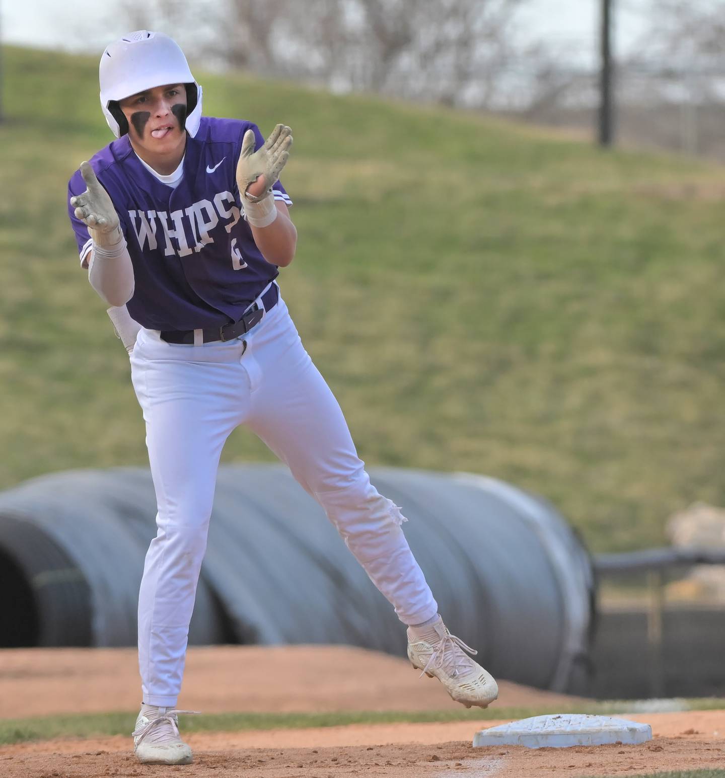 Hampshire’s Shane Pfeiffer applauds from third base during the Whips two-run second inning against Schaumburg in a baseball game in Schaumburg on March 28, 2025.