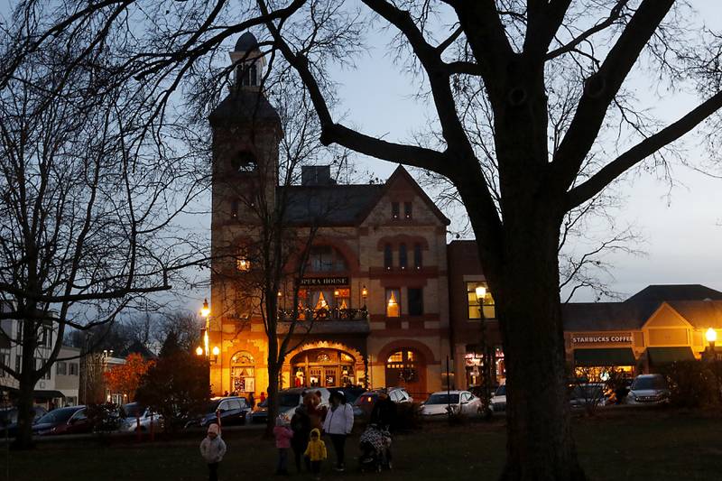 People begin to gather in front of the Woodstock Opera House before  the Lighting of the Square on Friday, Nov. 24, 2023, in Woodstock. The annual holiday season event featured brass music, caroling, free doughnuts and cider, food trucks, festive selfie stations and shopping.