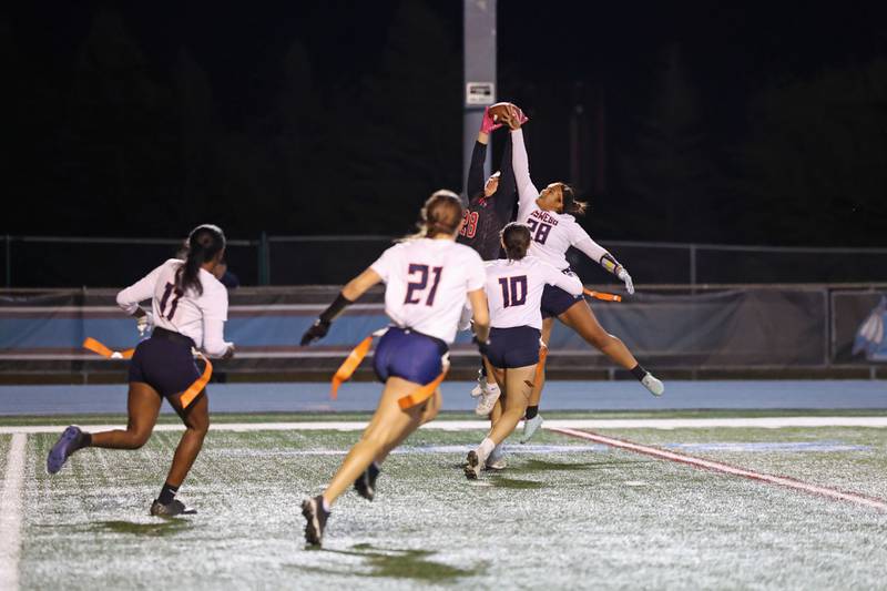 Yorkville's Kayla Kersting catches a pass under pressure from Oswego's Nathalia Wheeler during the Foxes' 2-1 overtime victory over Oswego in the IHSA Kankakee Regional championship game on Thursday, Oct. 9, 2025.