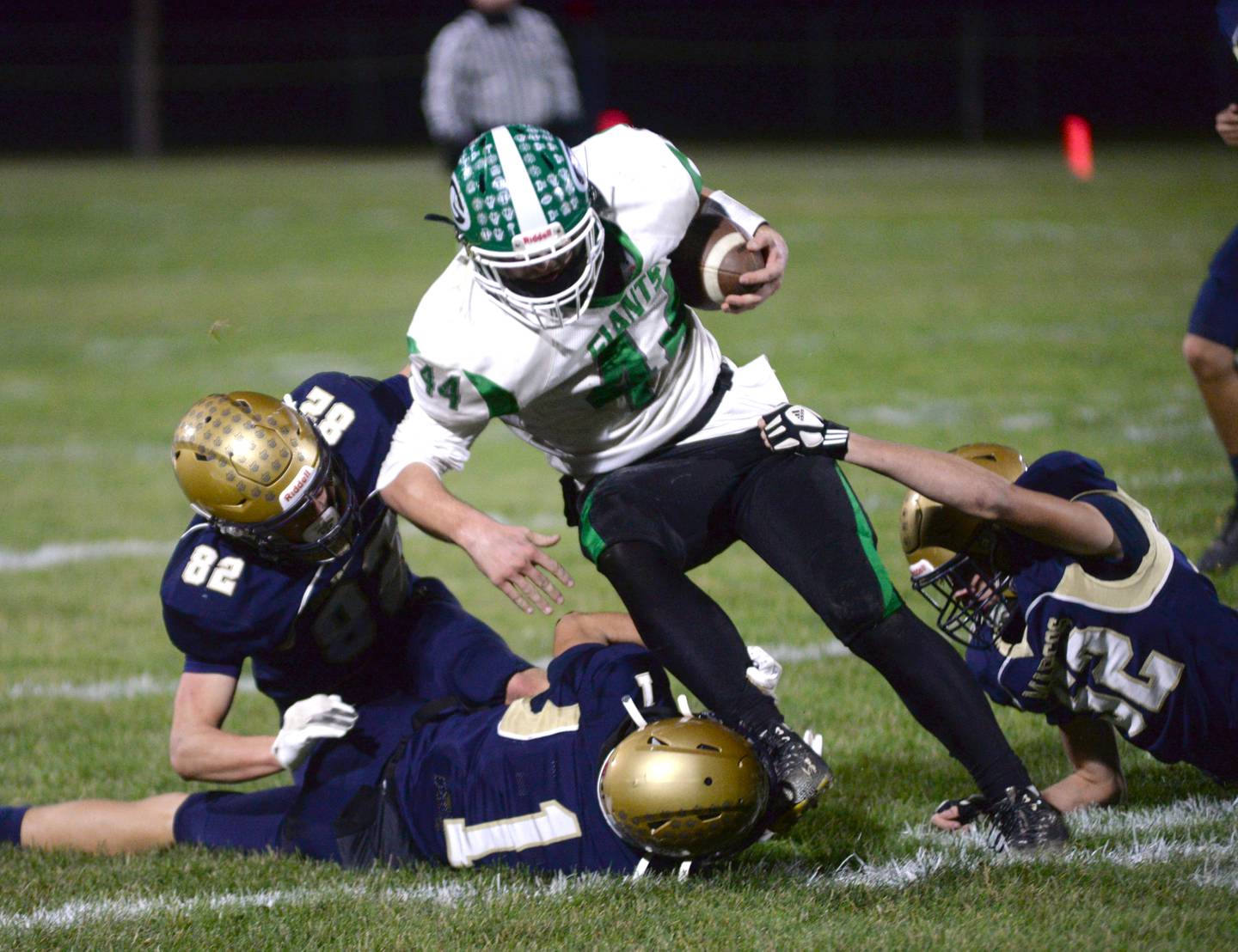Polo defenders Mercer Mumford (1), Kailin Gulbranson (82), and Billy Lowry (12) tackle Alden-Hebron's Wyatt Armbrust (44) during 8-man playoff action against on Friday, Nov. 1, 2024 in Polo.