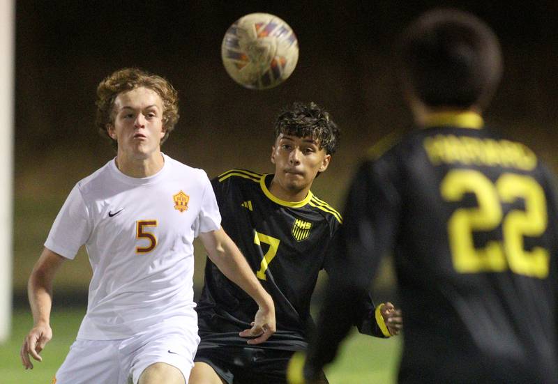 Harvard’s Jesus Aquino, center, and Richmond-Burton’s Nate Larson follow the ball in varsity soccer on Monday, Oct. 7, 2024, at Dan Horne Field on the campus of Harvard High School in Harvard.