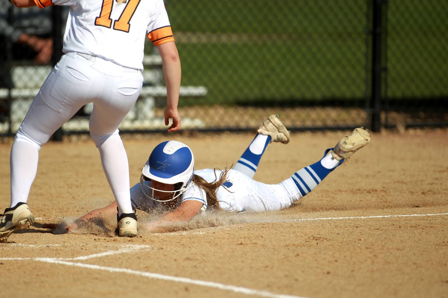 St. Charles North’s Ivy Gleeson slides safely into home base during a home game against Wheaton Warrenville South on Monday, May 6, 2024.