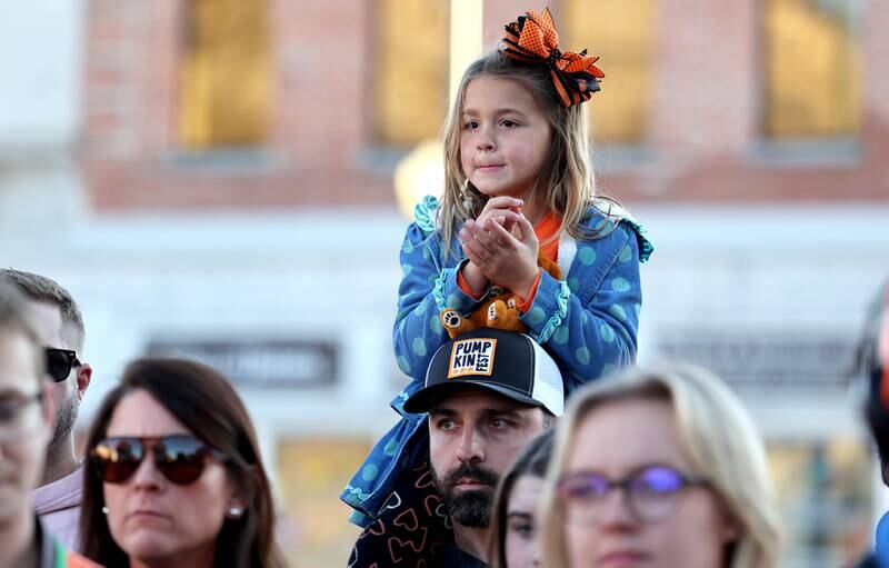 People await the cutting of the large cakes donated by Hy-Vee Wednesday, Oct.26, 2022 on North Maple Street near the DeKalb County Courthouse during the first day of the Sycamore Pumpkin Festival.