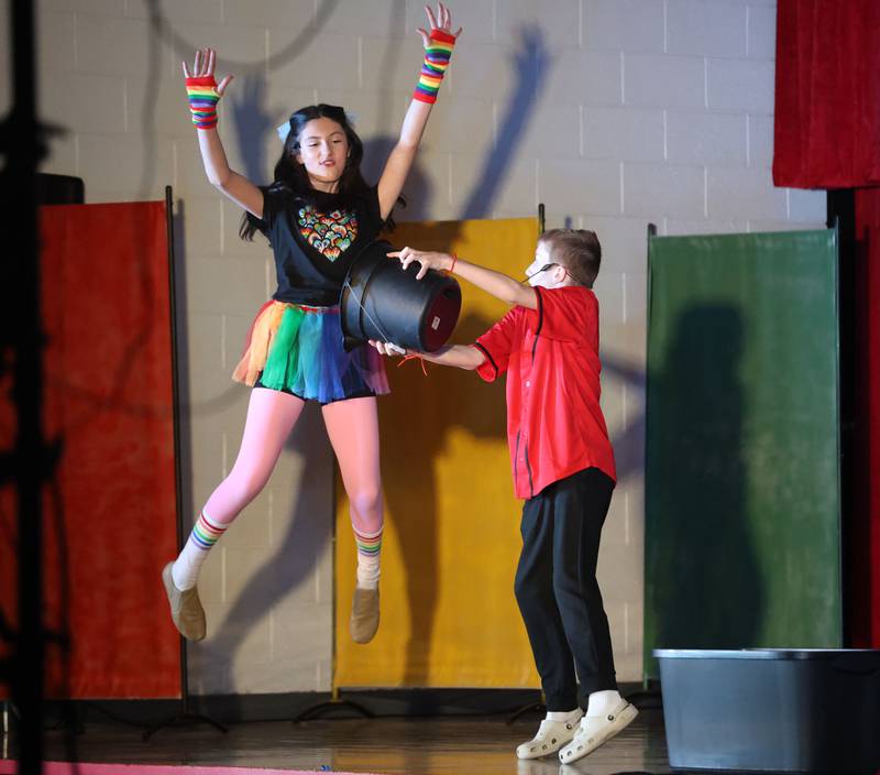 Cici Verucchi, reacts while Griffin Reed dumps a water bucket on her while performing in "Godspell  Jr." on Friday, March 27, 2026 at The Academy of Saints Carlo Acutis school in Oglesby.