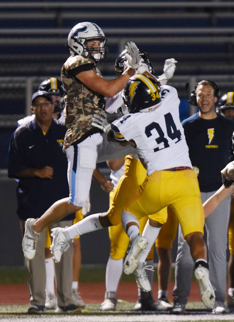 Joe Lewnard/jlewnard@dailyherald.com
Prospect’s Nicholas Carlucci, left, catches a pass in front of Glenbrook South's Nate Canning during Thursday’s game in Mount Prospect.