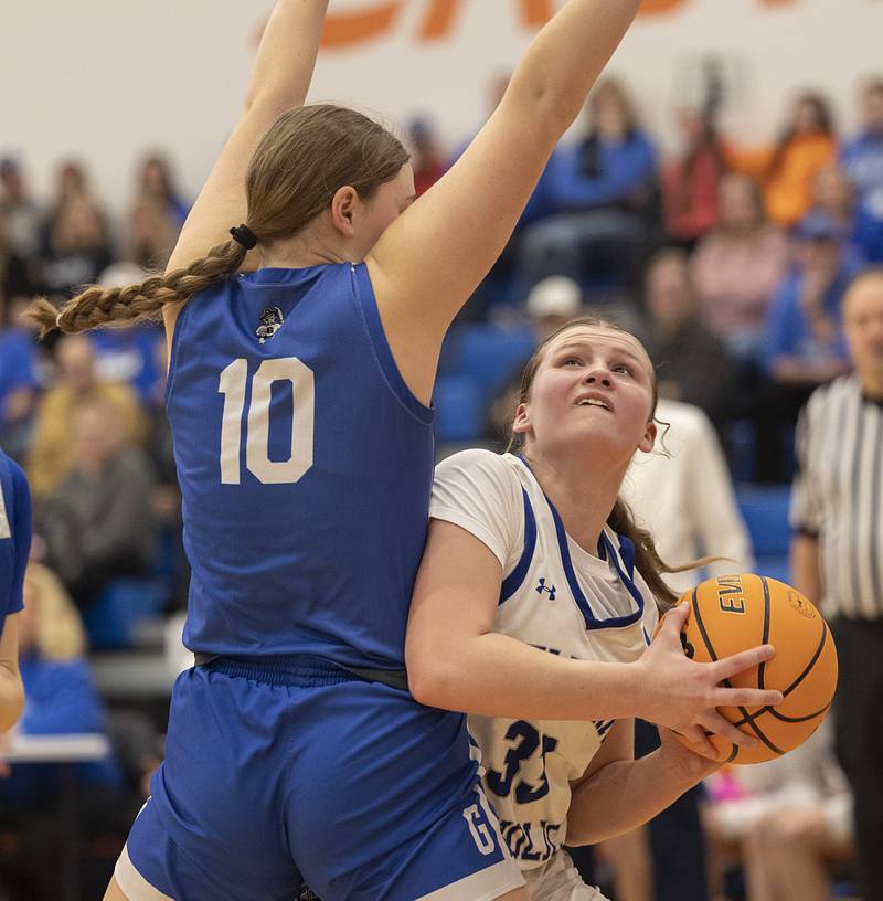 Newman’s Veronica Haley works below the basket against Galena’s Megan Koenigs Tuesday, Feb. 24, 2026, in the Class 1A sectional at Eastland High School.