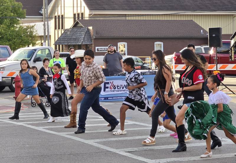 Amigo Fest attendees both young and old participate in a line dance Saturday, Sept. 21, 2024, in downtown Mendota.