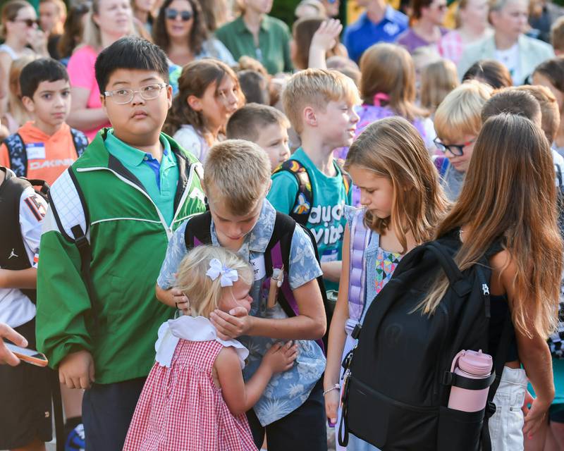 Third grader Knox Singer, 8, gives his younger sister Nora Singer, 3, a hug and kiss as he heads off for the first day of class on Thursday Aug. 21, 2025, at Western Avenue Elementary School in Geneva.